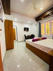 a bedroom with a bed and a dining room at Drizzle Valley Cottage in Munnar
