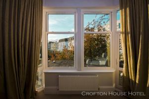 a window with a view of a city at Crofton House Hotel in Torquay