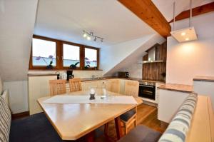 a kitchen with a table and a dining room at Großzügiges Appartment mit Balkon im Herzen von Tirol in Umhausen