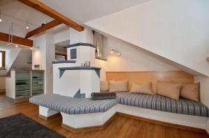 a living room with a couch and a staircase at Großzügiges Appartment mit Balkon im Herzen von Tirol in Umhausen