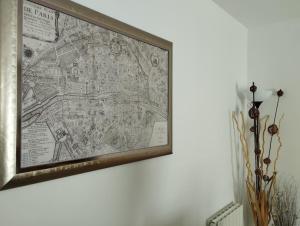 a map in a frame hanging on a wall at Appartement calme proche Paris in Villiers-sur-Marne
