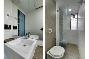 ムンバイにあるHOTEL BB HOUSEの洗面台とトイレ付きのバスルームの2枚