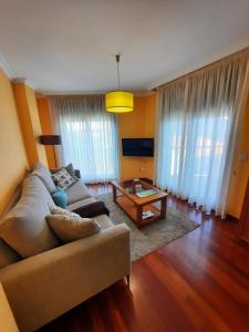 a living room with a couch and a coffee table at Apartamento en Beiramar in O Grove