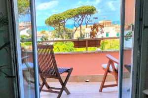 a chair on a balcony with a view of the ocean at Anzio Paradise in Anzio