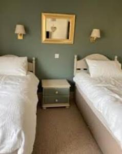 two beds sitting next to each other in a bedroom at Brandreth Barn in Burscough