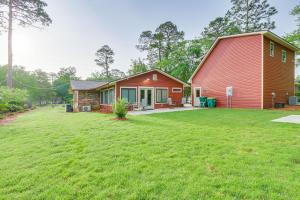 a home with a red barn and a yard at Charming Bluffton Vacation Home with Smart TVs! in Bluffton