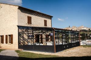a building with a large glass door on it at Locanda Fontezoppa in Civitanova Alta