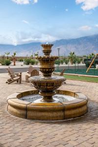 a fountain in the middle of a patio with a table at RV71-Lot- Paradise RV Park in Desert Hot Springs