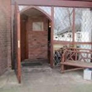 an entry way to a building with a brick wall at Brandreth Barn in Burscough