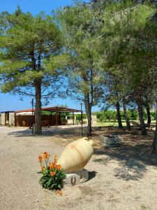 a large planter in a park with flowers and trees at Agriturismo Karrares in Melendugno