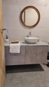 a bathroom with a sink and a mirror at Feliz descanso-acogedor/moderno in Tarija