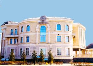 a large building with a clock on top of it at Royal BV in Ustʼ-Kamenogorsk
