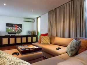 a living room with a couch and a tv at Villa Lilibel by Elite Havens in Seminyak