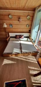 a bed in the back of a room with a window at Kleine Wohnung in Tiefenbach mit Sauna und Schwimmbad in Oberstdorf