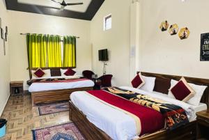 2 camas en una habitación con cortinas amarillas en Goroomgo Morning Moon Bhimtal Near Ramleela Ground - Comfortable Stay with Family, en Bhimtal