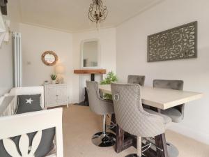 a dining room with a table and chairs at 12 Pennystone Road in Blackpool