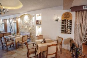 a restaurant with tables and chairs and a wine cellar at Hotel Kiko in Bitola