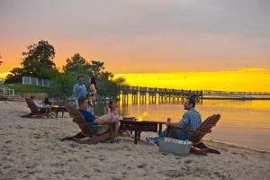 a group of people sitting at a table on the beach at Hyatt Regency Chesapeake Bay Golf Resort, Spa & Marina in Cambridge