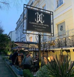 a sign for a restaurant in front of a building at Clarence Court Hotel in Cheltenham