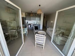 a living room with a table and chairs and a kitchen at APPARTEMENT Résidence RIVES D'EDEN in Sainte-Maxime +13 photos