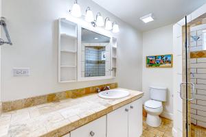 a bathroom with a sink and a toilet at Old Town Treasure in Port Aransas +22 photos
