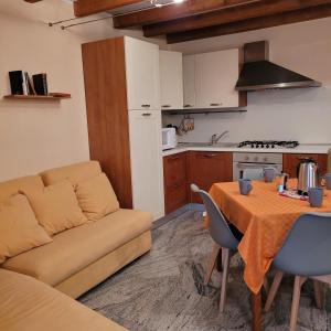 a living room with a couch and a table at Il Cortiletto Mountain Lake Iseo Hospitality in Costa Volpino