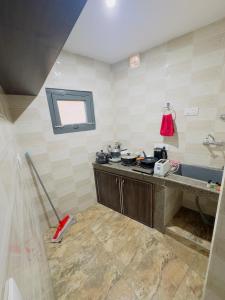a kitchen with a sink and a stove in it at Farmhouse - A Luxury Living in Srinagar +44 photos