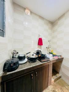a kitchen with pots and pans on a counter at Farmhouse - A Luxury Living in Srinagar