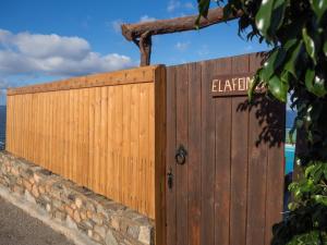 a wooden gate with a sign on it at Amazing sea views at villa Elafonissi with private pool, near Elafonissi beach in Chania +6 photos