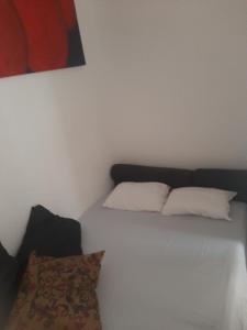 a bedroom with a bed with two pillows on it at Cantinho in Rio de Janeiro