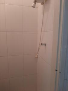 a bathroom with a shower with a shower wand at Cantinho in Rio de Janeiro