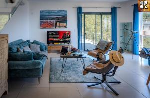 a living room with a dog laying on a chair at VILLA ROCCA BRUNA, LE CAP CORSE 5 ETOILES in Santa-Maria-di-Lota