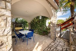 an outdoor patio with a table and chairs at Ferienwohnung für 4 Personen ca 50 qm in Njivice, Kvarner Bucht Krk in Njivice