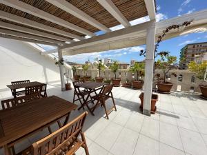 a patio with tables and chairs on a roof at B&B Albergo Sicilia in Avola