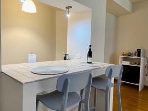 a kitchen with a table with a bottle of wine on it at Casa di Chica in Castiglione Falletto +11 photos