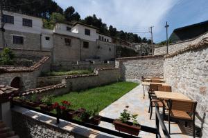a patio with tables and chairs in a building at Vila Meri in Berat