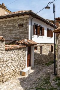 a stone house with a door in a street at Vila Meri in Berat +24 photos