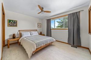 a bedroom with a bed and a ceiling fan at Field of Dreams in Picton