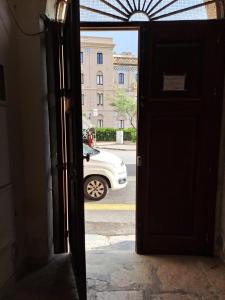 uma porta aberta com um carro estacionado numa rua em la casa del nonno em Trapani