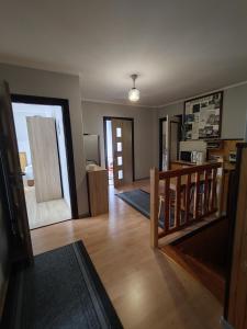 a living room with a staircase and a kitchen and a living room at Agroturystyka Elżbieta i Juliusz in Muszyna