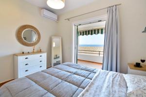 a bedroom with a bed and a view of the ocean at Two-bedroom Condo with Sea View in Glyfada in Glyfada