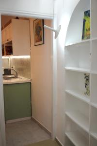 a kitchen with white shelves and a sink at Lithi Stylish Apartments- Cosy in Tripití