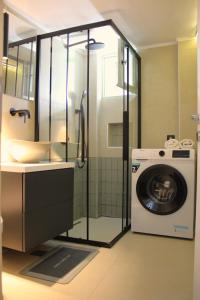 a bathroom with a washing machine and a washer at Lithi Stylish Apartments- Cosy in Tripiti