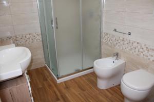 a bathroom with a shower and a toilet and a sink at Agriturismo Karrares in Melendugno