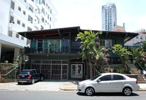 a white car parked in front of a house at HOSTAL IBRAIS in Panama City