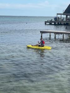 a man sitting on a yellow kayak in the water at Aqua Vista in San Pedro