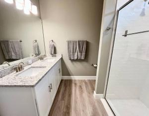 a bathroom with two sinks and a shower at The Billiard close to downtown with fenced yard in Sanford