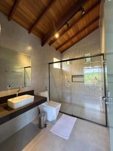 a bathroom with a sink and a shower and a toilet at Hotel Fazenda Palmeiras in Rio Casca