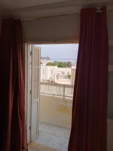 an open window with a view of a balcony at Nour in Sousse