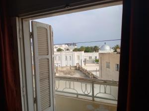 a window with a view of a building at Nour in Sousse
